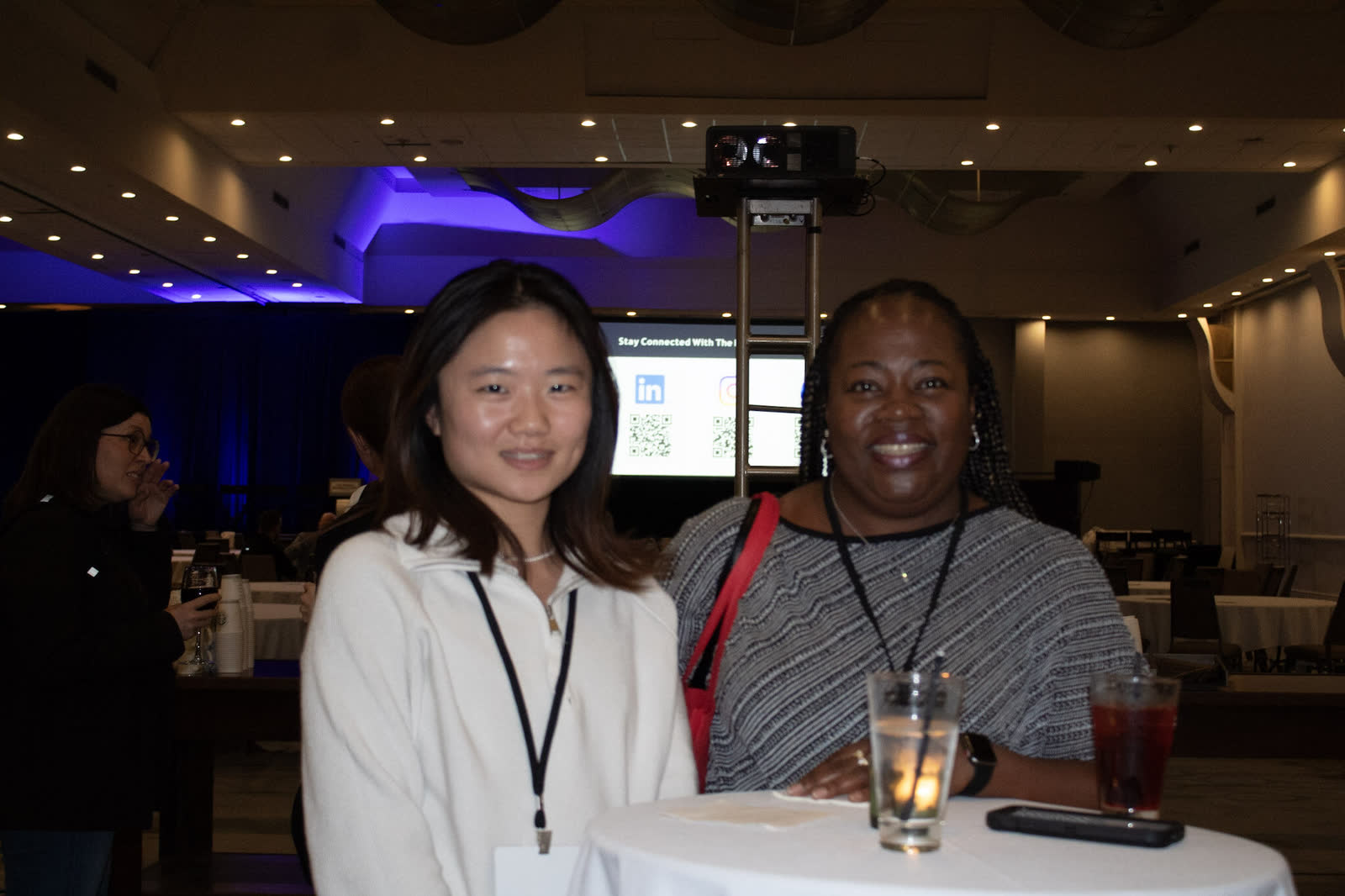 Two I4PL delegates talking at the conference networking reception