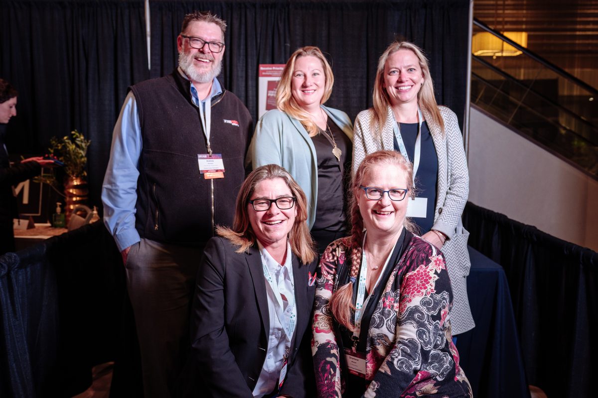 Members posing together at a conference.